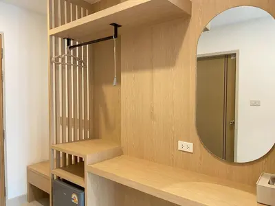 a bathroom with a mirror and a wooden shelf at Luna Residence in Ban Bang Phai