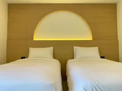 two beds sitting next to each other in a room at Luna Residence in Ban Bang Phai