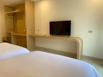 a bedroom with a bed and a flat screen tv at Luna Residence in Ban Bang Phai