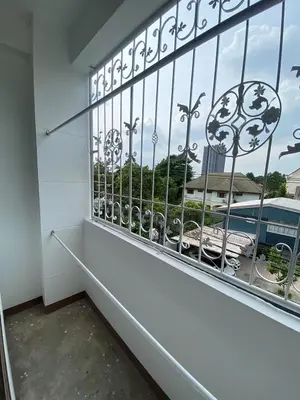 a balcony with a window with a view of a building at Homey Place 2 in Ban Song Hong