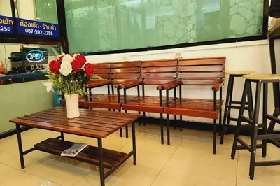 a group of benches with a vase of flowers on them at Zenith Life Hotel in Ban Bang Khen (1)