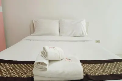 a bed with two towels on top of it at Zenith Life Hotel in Ban Bang Khen (1)
