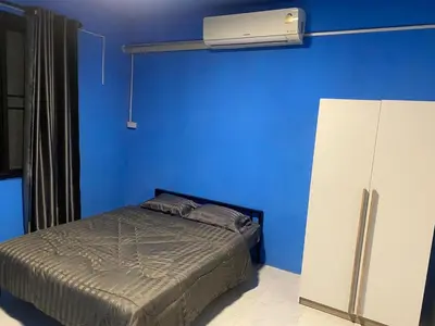 a blue bedroom with a bed and a blue wall at Am Am Place C แอม แอม เพลส C Near Rajmangkala Stadiume in Sathani Khlong Tan
