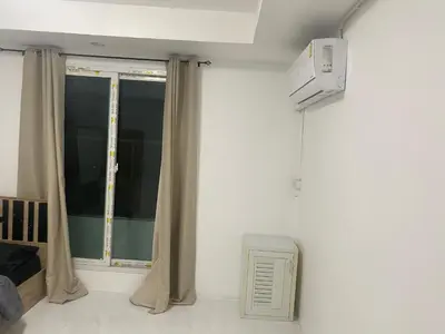 a room with a window with curtains and a television at Am Am Place C แอม แอม เพลส C Near Rajmangkala Stadiume in Sathani Khlong Tan
