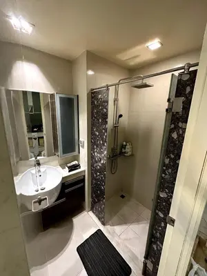 a bathroom with a sink and a shower at Sky Residence in Ekkamai in Bangkok