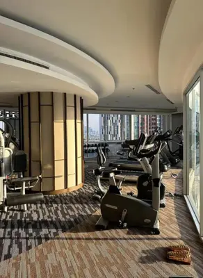 a gym with treadmills and exercise equipment in a building at Sky Residence in Ekkamai in Bangkok