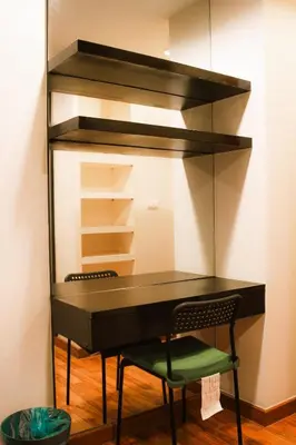 a black desk with a chair in a room at Zenith Place Huge 2BR Low-rise condo in Bangkok