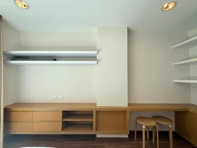 a kitchen with two stools and a counter with shelves at Zenith Place Huge 2BR Low-rise condo in Bangkok