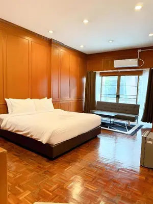 a bedroom with a bed and a bench in it at xx Stay On Sukhumvit Soi 11 BTS Nana in Bangkok