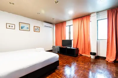 a hotel room with a bed and a television at xx Stay On Sukhumvit Soi 11 BTS Nana in Bangkok