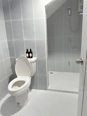 a white bathroom with a toilet and a shower at xx Stay On Sukhumvit Soi 11 BTS Nana in Bangkok
