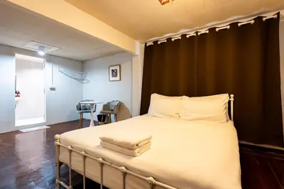 a bedroom with a large bed with white sheets at xx Stay On Sukhumvit Soi 11 BTS Nana in Bangkok