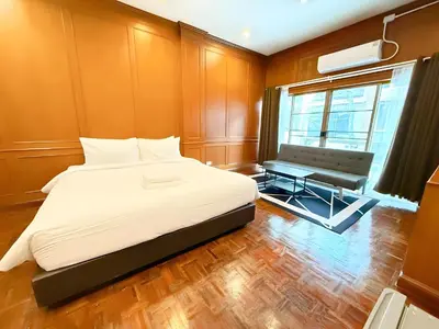 a bedroom with a bed and a bench and a window at xx Stay On Sukhumvit Soi 11 BTS Nana in Bangkok