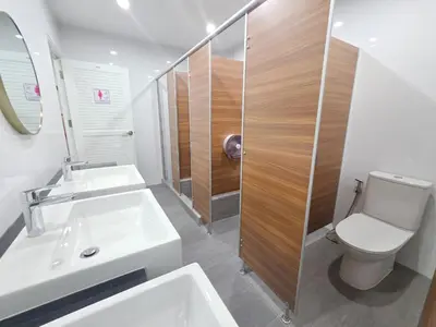 a bathroom with two sinks and a toilet and a shower at Vintana Siam Bangkok Hotel in Bangkok