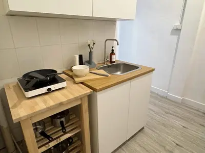 a kitchen with a sink and a counter top at Vélin - Banthat Thong in Bangkok