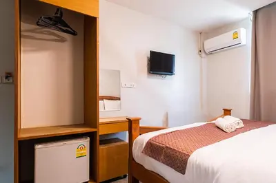 a small room with a bed and a tv at XX GO INN Khaosan - โกอินน์ ถนนข้าวสาร in Bangkok