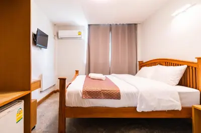 a bedroom with a bed and a television in a room at XX GO INN Khaosan - โกอินน์ ถนนข้าวสาร in Bangkok