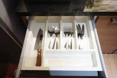 a drawer with knives and forks and spoons at Executive Suite 1BR and Sofa Bed 150m to Nana BTS in Bangkok