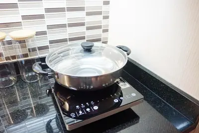 a pot on top of a stove in a kitchen at Executive Suite 1BR and Sofa Bed 150m to Nana BTS in Bangkok