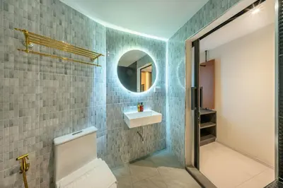 a bathroom with a sink and a mirror at U TOR Yaowarat - Bangkok Chinatown in Bangkok