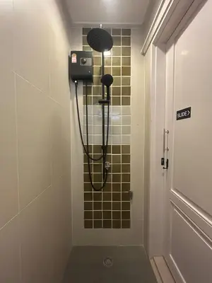 a shower in a bathroom with a shower head at Entire Home 2BR 2BA Chinatown near Yaowarat - Songwat in Bangkok