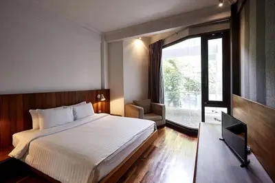 a bedroom with a large bed and a window at XX Wish Inn Silom BKK - วิช อินน์ สีลม in Bang Rak
