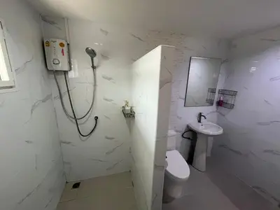 a bathroom with a shower and a toilet and a sink at Baan Saen Saran guest house in Bangkok