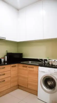 a kitchen with a washer and a washing machine at The Condo C - Luxury Condo with Onsen in Bangkok