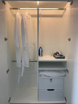 a closet with white cabinets and white clothes at The Elite Club - ThongLor Bangkok in Bangkok
