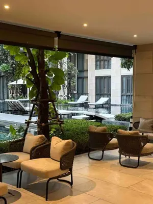 a lobby with chairs and tables in a building at Luxury Japanese Onsen Reserve - Bangkok in Bangkok