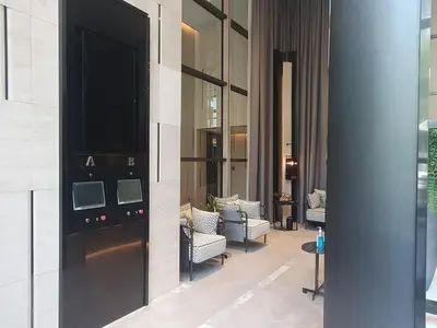 a lobby of a building with a door and chairs at Luxury Japanese Onsen Reserve - Bangkok in Bangkok
