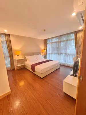 a bedroom with a bed and a television in it at ICON NARINDRA SUITES HOTEL Sukhumvit Bangkok Thailand 50sqm to 90sqm Rooms & FREE Minibar in Bangkok