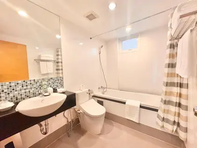a bathroom with a sink and a toilet and a tub at ICON NARINDRA SUITES HOTEL Sukhumvit Bangkok Thailand 50sqm to 90sqm Rooms & FREE Minibar in Bangkok