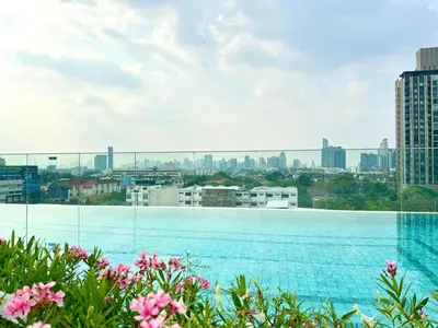 a view of a large swimming pool with a city skyline at Cosy apartment in Bangkok