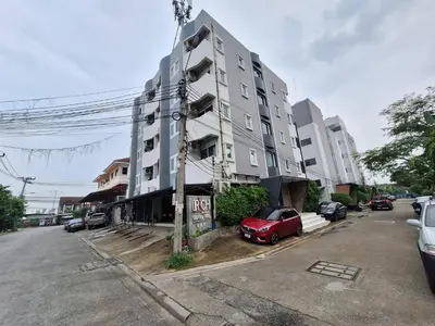 a building with a red car parked in front of it at Irich Bang Hua Suae 6kms from BTS Pu-Chao in Ban Bang Chak