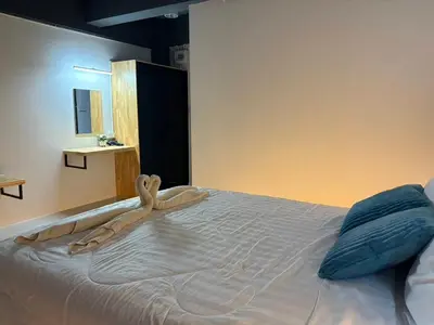 a large bed with a person laying on it at Irich Bang Hua Suae 6kms from BTS Pu-Chao in Ban Bang Chak