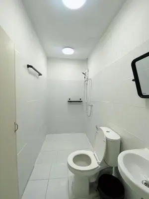 a white bathroom with a toilet and a sink at XX GO INN Siriraj BKK - โกอินน์ ศิริราช in Bangkok Noi