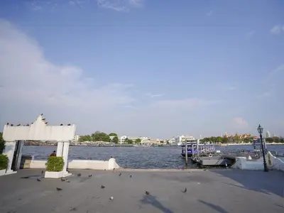 a dock with a boat in the water at XX GO INN Siriraj BKK - โกอินน์ ศิริราช in Bangkok Noi