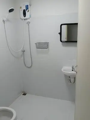 a white bathroom with a shower and a toilet at XX GO INN Siriraj BKK - โกอินน์ ศิริราช in Bangkok Noi