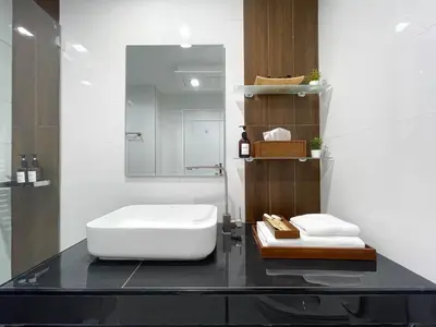 a bathroom with a white sink and a mirror at Modern Cityscape1BR - Ultra Fast WiFi - BTS On nut in Bangkok
