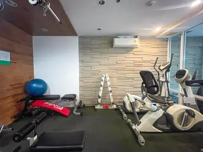 a gym with several exercise equipment in a room at Modern Cityscape1BR - Ultra Fast WiFi - BTS On nut in Bangkok
