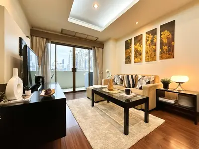 a living room with a couch and a table at Vibrant Modern 57 SQM - Ultra Fast WiFi - BTS Thonglor in Bangkok