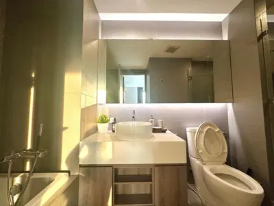 a bathroom with a sink and a toilet and a mirror at Elegant & Low Rise 2 Bedrooms in Bangkok