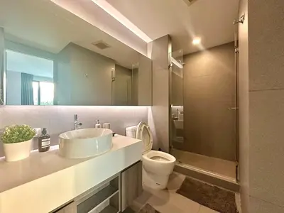 a bathroom with a sink and a toilet and a shower at Elegant & Low Rise 2 Bedrooms in Bangkok