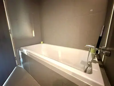 a white bath tub in a bathroom with at Elegant & Low Rise 2 Bedrooms in Bangkok