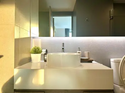 a bathroom with a sink and a mirror at Elegant & Low Rise 2 Bedrooms in Bangkok