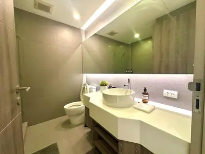 a bathroom with a sink and a toilet and a mirror at Elegant & Low Rise 2 Bedrooms in Bangkok