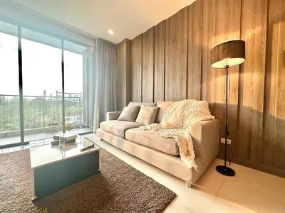 a living room with a couch and a large window at Elegant & Low Rise 2 Bedrooms in Bangkok