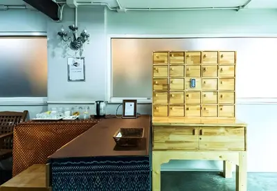 an office with a desk and a wooden cabinet at XX GO INN Khaosan - โกอินน์ ถนนข้าวสาร in Bangkok