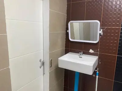 a bathroom with a sink and a mirror at Am Am Place D Near Rajamangala in Sathani Khlong Tan